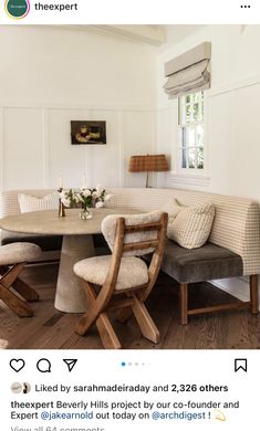 a table and chairs in a room with white walls