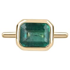 For Sale on 1stDibs - Displayed is a vibrant-green emerald, solitaire, emerald-cut bezel ring in 14K yellow gold. This gorgeous solitaire ring carries a full 3.85-carat emerald Stone Gold Ring, Bezel Set Engagement Ring, Bezel Engagement Ring, Jupiter Fl, Bezel Set Ring, Emerald Cut Rings, Solitaire Setting, Emerald Engagement Ring Cut, Right Hand Rings