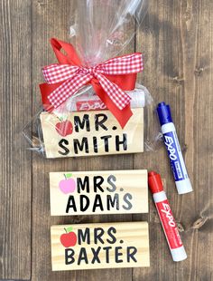 two wooden signs with the words mr and mrs written on them, one has a red bow