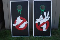 two black and white signs with ghost characters on them, one has green dripping paint