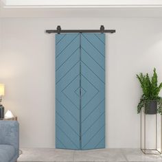 a living room with a blue door and two planters on the side of the wall