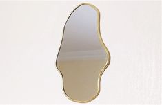 an oval shaped mirror hanging on the wall