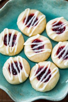 small cookies with white icing on a blue plate