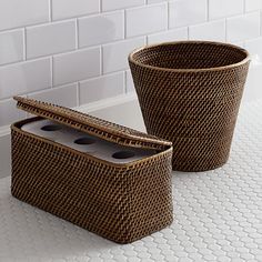 two brown baskets sitting on top of a white counter