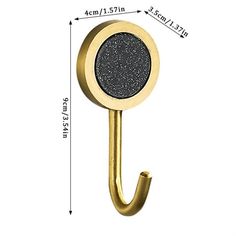 an image of a gold hook with black glitter on it