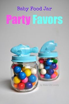 baby food jar party favors with fish and gumballs in the bottom one is blue