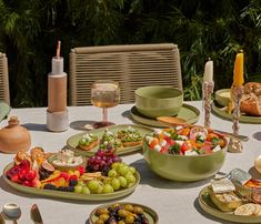 a table topped with plates and bowls filled with different types of food on top of it