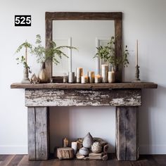 a mantle with candles and plants on it in front of a mirror that reads 525