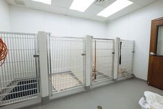 an empty room with white walls and bars on the doors