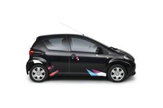 a small black car with colorful arrows painted on it