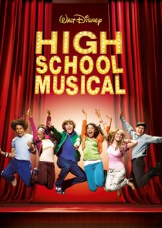 the cast of high school musical jumping in front of a red curtain with their arms up