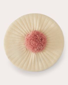 a white and pink pom - pom on top of a table