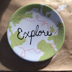 a paper plate with the word explore painted on it