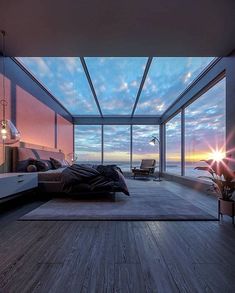 a bedroom with an ocean view is shown in this image, it appears to be very large