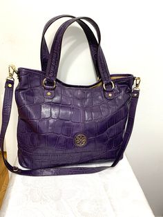 this is a lovely Antonio Melani embossed purple leather large bag purse shoulder bag.' Main compartment with a snap closure the inside has a wall zippered pocket 2 slip pockets and a padded mid section zippered pocket . Measures app 17"x14"x5"  shoulder strap is 20"drop. Condition is excellent . Comes from a smoke free home. Purple Leather Rectangular Hobo Bag, Soft Leather Purple Shoulder Bag, Purple Soft Leather Shoulder Bag, Daily Use Purple Soft Leather Shoulder Bag, Purple Leather Hobo Tote Bag, Purple Hobo Bag With Removable Pouch For Daily Use, Purple Hobo Tote Bag For Everyday Use, Purple Tote Hobo Bag For Everyday Use, Purple Shoulder Bag With Zipper For Travel