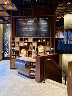 the inside of a store with many items on shelves and signs above it that read starbucks reserve roastery