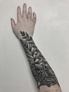 a person's arm with a tattoo on it and an animal in the middle