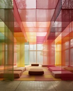 the room is filled with different colored squares and couches in front of large windows