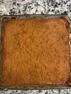 a casserole dish on a granite countertop, ready to be baked in the oven