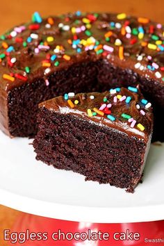 a chocolate cake with sprinkles on a white plate