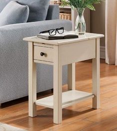 a small table with a book and glasses on it