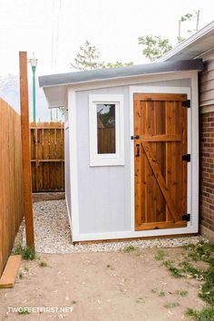 a small shed with a wooden door and window