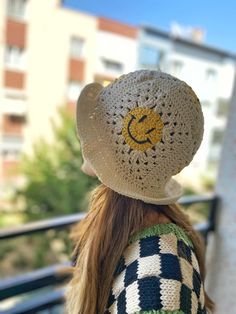 the back of a woman's head wearing a crocheted hat