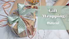 gift wrapping with ribbon and flowers on the table