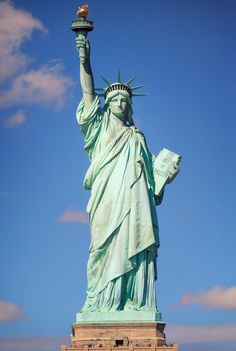 the statue of liberty is shown against a blue sky