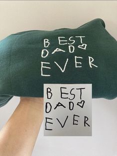 a pillow with the words best dad ever written on it and a hand holding a piece of paper that says best dad ever