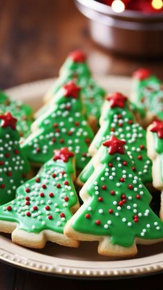 christmas cookies decorated with green and red icing on a plate