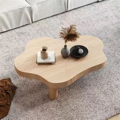 a coffee table with two records on it and a plant sitting on top of it