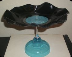 a blue glass bowl sitting on top of a table