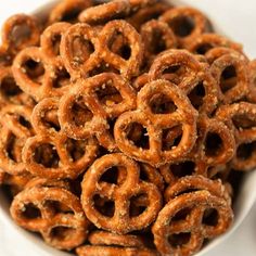 a white bowl filled with onion rings on top of a table