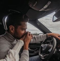 a man sitting in the driver's seat of a car