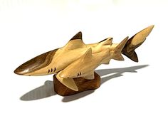 a wooden sculpture of a shark on a white background