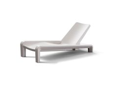 a white lounge chair sitting on top of a white floor