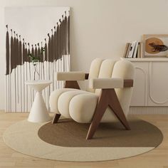 a white chair sitting on top of a wooden floor next to a wall mounted painting