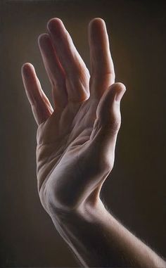 a person's hand reaching up into the air