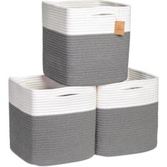 three grey and white baskets stacked on top of each other