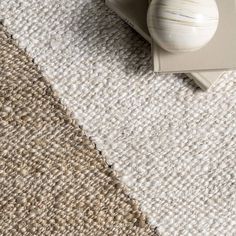 a close up of a rug on the floor with an object in front of it