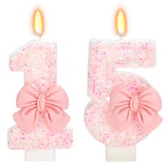 the number five candle has pink bows on it