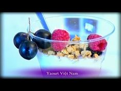 yogurt, granola and berries in a glass bowl with the words yogurt viet nam