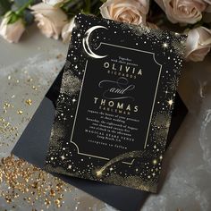 an elegant black and gold wedding card with stars, moon and swirls on it