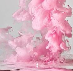 pink ink is being mixed in with water