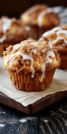 cinnamon muffins with icing on a wooden tray