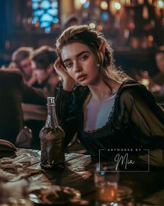 a woman sitting at a table with a bottle in front of her