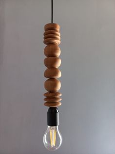 a wooden light bulb hanging from a ceiling