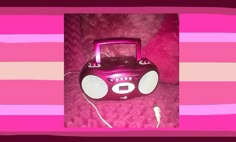 a pink radio sitting on top of a pink blanket