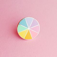 a pin sitting on top of a pink surface